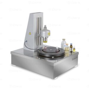 Tabletop machine for automatic closing of vials and bottles